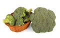 Fresh broccoli in basket and one near, close-up isolated on whit Royalty Free Stock Photo