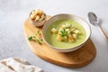 Fresh broccoli soup with croutons and micro green in a bowl on gray background. Spring vegan recipe, healthy food, detox, menu. Royalty Free Stock Photo