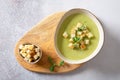 Fresh broccoli soup with croutons and micro green in a bowl on a gray background. Spring vegan recipe, healthy food, detox, menu. Royalty Free Stock Photo