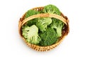 fresh broccoli in wicker basket isolated on white background close-up with full depth of field. Top view. Flat lay Royalty Free Stock Photo