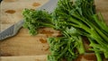 Fresh Broccolini vegetables on a cutting board