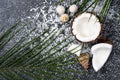 Fresh broken coconut with shavings on black