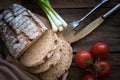 Fresh brown bread on a wooden plate with vegetables Royalty Free Stock Photo