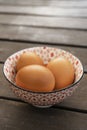 Fresh brown eggs in a beautiful bone china bowl