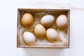 Fresh brown eggs and some straw in a wooden crate Royalty Free Stock Photo
