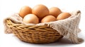 Fresh brown eggs in a wicker basket on a rustic burlap cloth Royalty Free Stock Photo