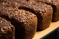 fresh brown loaves of rye bread in the form of bricks with sunflower seeds on a crust. Lie on a wooden rack Royalty Free Stock Photo