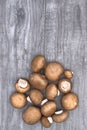 Fresh brown mushrooms on a wooden background.