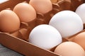 Fresh Brown and White Chicken Eggs in a Box on wooden table.