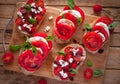 Bruschetta with cheese, tomatoes, fresh basil and balsamic vinegar on cutting board, top view Royalty Free Stock Photo