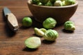 Fresh Brussels sprouts, bowl and knife on table Royalty Free Stock Photo