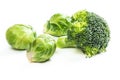 Fresh brussels sprouts and broccoli on white background.