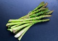 Fresh bunch asparagus on blue table background