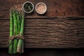 Fresh bunch of asparagus on a very old wood chopping board with a special texture Royalty Free Stock Photo