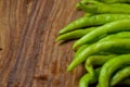 Fresh Bunch of green chili peppers on Chopper Board Close up Look Royalty Free Stock Photo