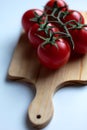 Sweet vine ripened tomatoes on wooden board Royalty Free Stock Photo