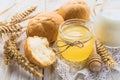 Fresh buns, milk, wheat spikelets and honey Royalty Free Stock Photo