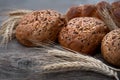 Fresh buns with whole grains on a wooden table Royalty Free Stock Photo