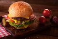 Fresh burger closeup. Wooden rustic background. Top view