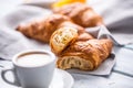 Fresh buttery croissants with coffee. Sweet morning breakfast concept Royalty Free Stock Photo