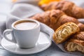 Fresh buttery croissants with coffee. Sweet morning breakfast concept