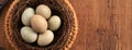 Fresh button quail eggs in a nest on wooden table background Royalty Free Stock Photo