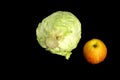 Fresh cabbage and a delicious Apple on a black background Royalty Free Stock Photo