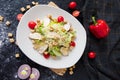 Fresh caesar salad with chicken on a white plate on dark stone background. Flat lay with ingridients for cook. Royalty Free Stock Photo