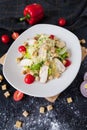 Fresh caesar salad with chicken on a white plate on dark stone background. Flat lay with ingridients for cook. Royalty Free Stock Photo