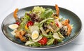 Fresh caesar salad on white bowl with parmesan cheese and shrimps. In a decorative plate Royalty Free Stock Photo