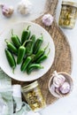 Fresh and canned jalapeno peppers on a rustic wooden board. Royalty Free Stock Photo