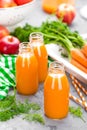 Fresh carrot and apple juice on white background. Carrot and apple juice in glass bottles on white table. Apple and carrot juice Royalty Free Stock Photo