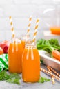 Fresh carrot and apple juice on white background. Carrot and apple juice in glass bottles on white table. Apple and carrot juice Royalty Free Stock Photo