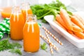 Fresh carrot and apple juice on white background. Carrot and apple juice in glass bottles on white table. Apple and carrot juice Royalty Free Stock Photo