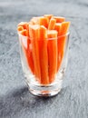 Fresh carrot batons in a glass container