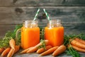 Fresh Carrot and carrot juice on Wooden Table in Garden. Vegetables Vitamins Keratin. Natural Organic Carrot lies on Royalty Free Stock Photo