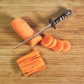 Fresh carrot chopped into slices on wooden table