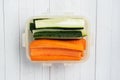 Fresh carrot and cucumber sticks in a container. Centimeter measurement of volume. Concept of dietary nutrition. Copy