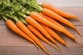 Fresh carrot harvest arranged in an appealing bunch on wooden table Royalty Free Stock Photo