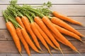 Fresh carrot harvest arranged in an appealing bunch on wooden table Royalty Free Stock Photo