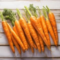 Fresh carrot harvest arranged in an appealing bunch on wooden table Royalty Free Stock Photo