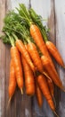 Fresh carrot harvest arranged in an appealing bunch on wooden table Royalty Free Stock Photo