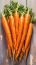 Fresh carrot harvest arranged in an appealing bunch on wooden table Royalty Free Stock Photo