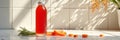Fresh carrot juice bottle on sunlit kitchen counter Royalty Free Stock Photo
