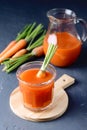 Fresh Carrot Juice in a Glass on a Dark Grey Background Healthy Drink Detox Diet Juice Glass of Tasty Carrot Juice on Wooden Board