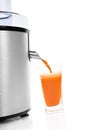 Fresh carrot juice with juicer. Royalty Free Stock Photo