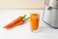 Fresh carrot juice with juicer Royalty Free Stock Photo