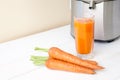 Fresh carrot juice with juicer Royalty Free Stock Photo