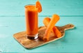 Fresh Carrot Juice with raw carrots served in a glass isolated on cutting board side view healthy fruit juice Royalty Free Stock Photo