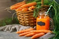 Fresh Carrot and carrot juice on Wooden Table in Garden. Vegetables Vitamins Keratin. Natural Organic Carrot lies on Royalty Free Stock Photo